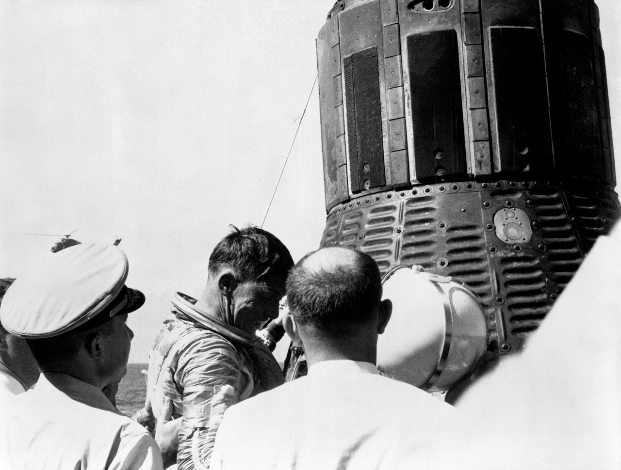 S62-06148 (3 Oct. 1962) --- Close-up view of Mercury-Atlas 8 (MA-8) astronaut Walter Schirra being removed from his Sigma 7 capsule by Navy personnel. Schirra has just removed his helmet. Photo credit: NASA