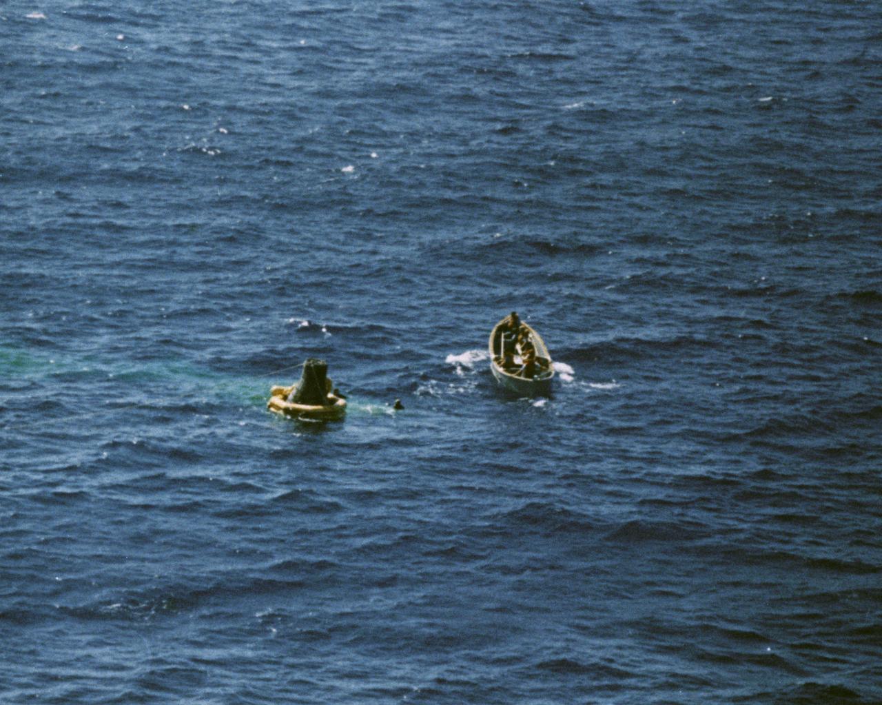 S62-09049 (3 Oct. 1962) --- Aerial view of a life boat from the USS Kearsarge, recovery ship, approaching the floating Sigma 7 capsule for the Mercury-Atlas 8 (MA-8) mission. Photo credit: NASA