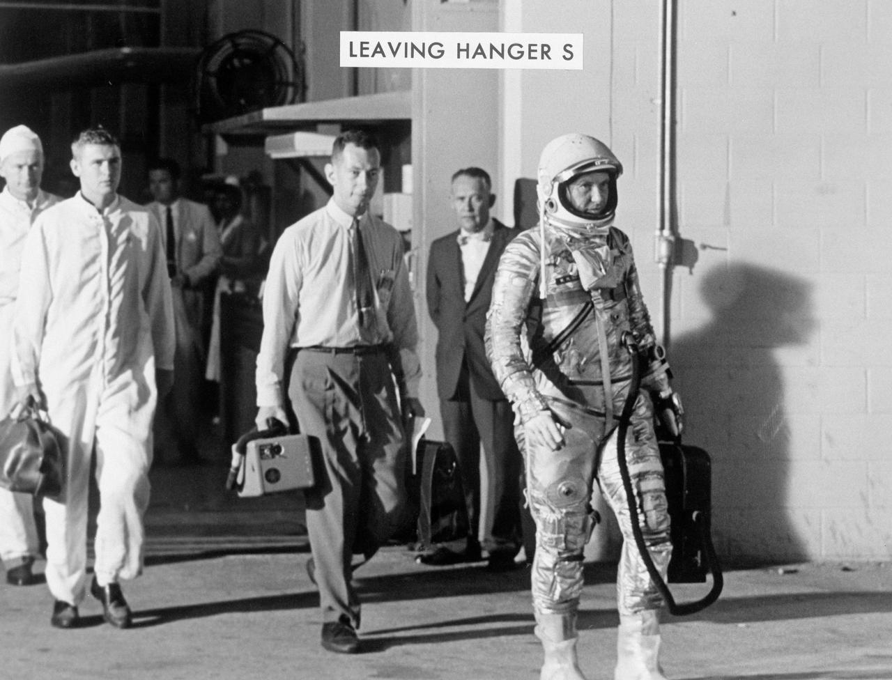 S63-00695 (3 Oct. 1962) --- Astronaut Walter M. Schirra Jr., pilot of the Mercury-Atlas 8 (MA-8) Earth-orbital spaceflight, leaves Hangar "S" at Cape Canaveral on his way to his scheduled Oct. 3, 1962 flight. Photo credit: NASA