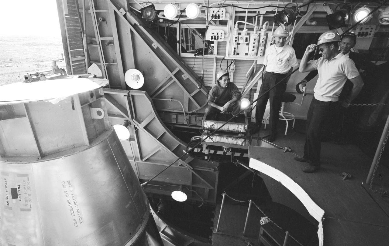 S63-03986 (1963) --- Astronaut L. Gordon Cooper Jr., prime pilot for the Mercury-Atlas 9 (MA-9) mission, and General Dynamics pad technicians watch Atlas 130D being hoisted into place in the gantry at pad #14, Cape Canaveral, Florida. Photo credit: NASA