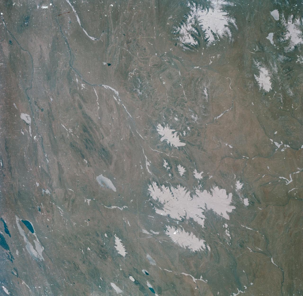 S63-06440 (15-16 May 1963) --- View of the Tibetan Plateau in north-central Tibet, as photographed from the Mercury-Atlas 9 (MA-9) capsule by astronaut L. Gordon Cooper Jr., during his 22-orbit MA-9 spaceflight. The center of the photograph is near 91 degrees east longitude and 34 degrees 30 minutes north latitude. This view includes lakes and snow-covered highlands. Photo credit: NASA