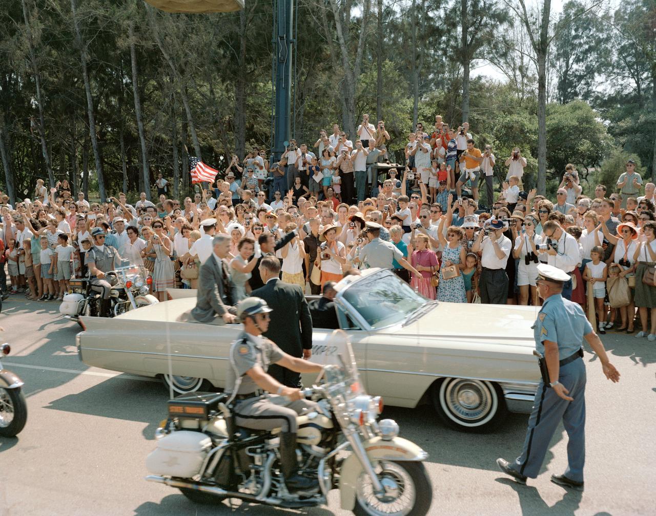 S63-07645 (1963) --- Astronaut L. Gordon Cooper Jr. and his wife at Patrick Air Force Base rides a convertible in a parade given in his honor. Photo credit: NASA