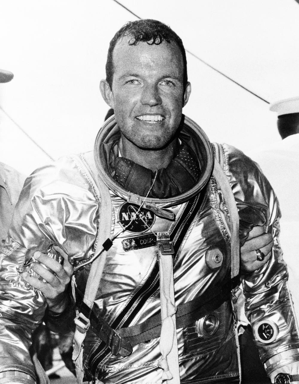 S63-07853 (16 May 1963) --- Astronaut L. Gordon Cooper Jr., pilot of the Mercury-Atlas 9 (MA-9) mission, stands supported by strong hands after climbing out of his spacecraft "Faith 7" after a 600,000-mile, 22-orbit journey around Earth. He elected to remain in the spacecraft until it was hoisted to the deck of the USS Kearsarge, as did astronaut Walter Schirra during the previous mission. Photo credit: NASA