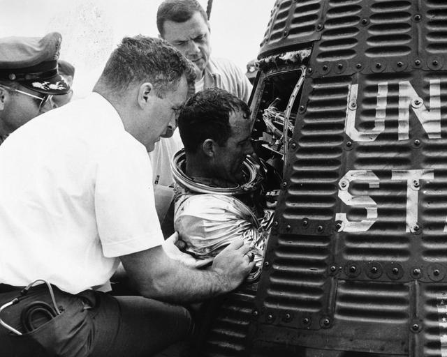 NASA image: Astronaut Gordon Cooper is assisted backing out of his spacecraft "Faith 7"