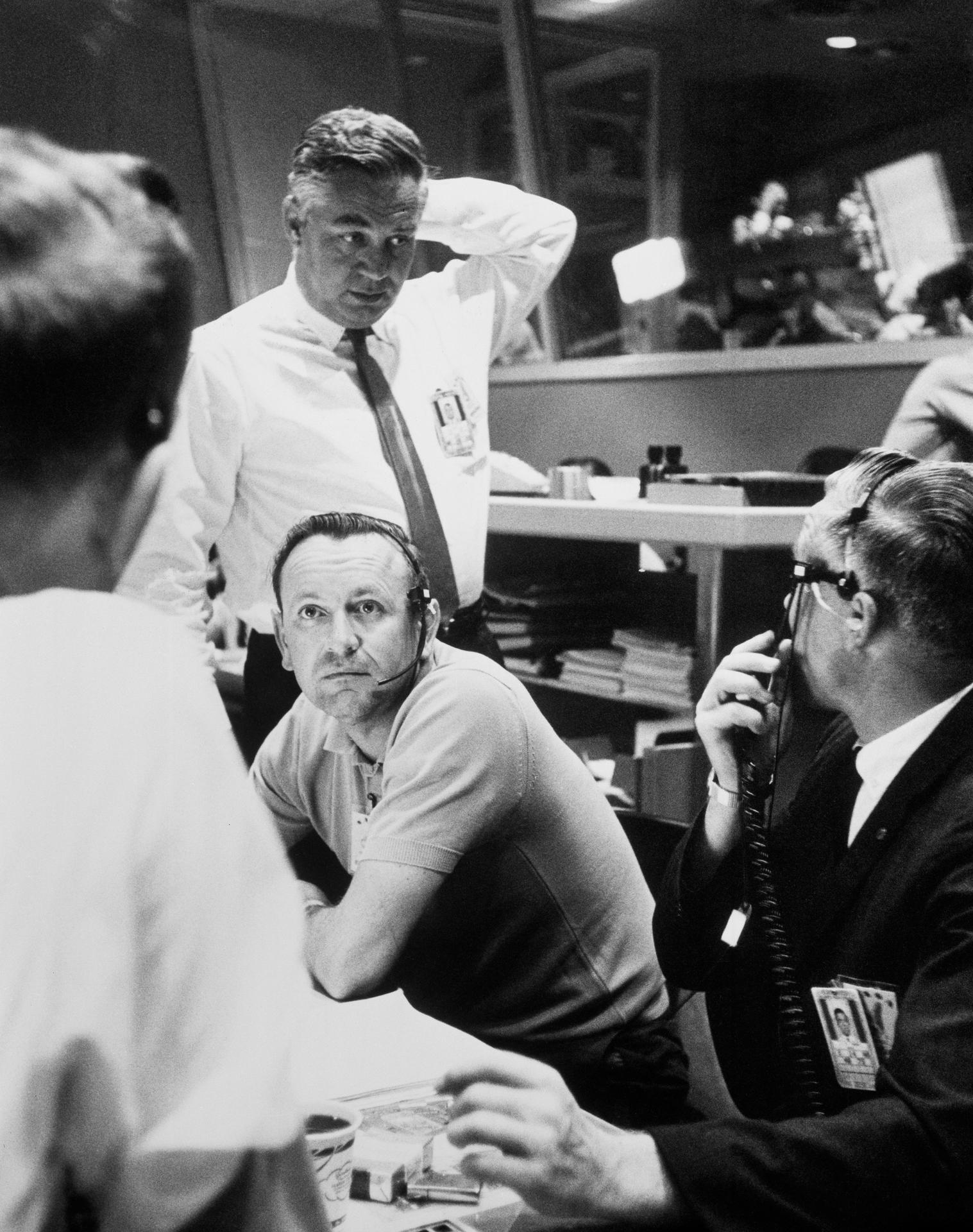 Christ Kraft, seated in the center of this photo, works with others in the Mercury Control Center
