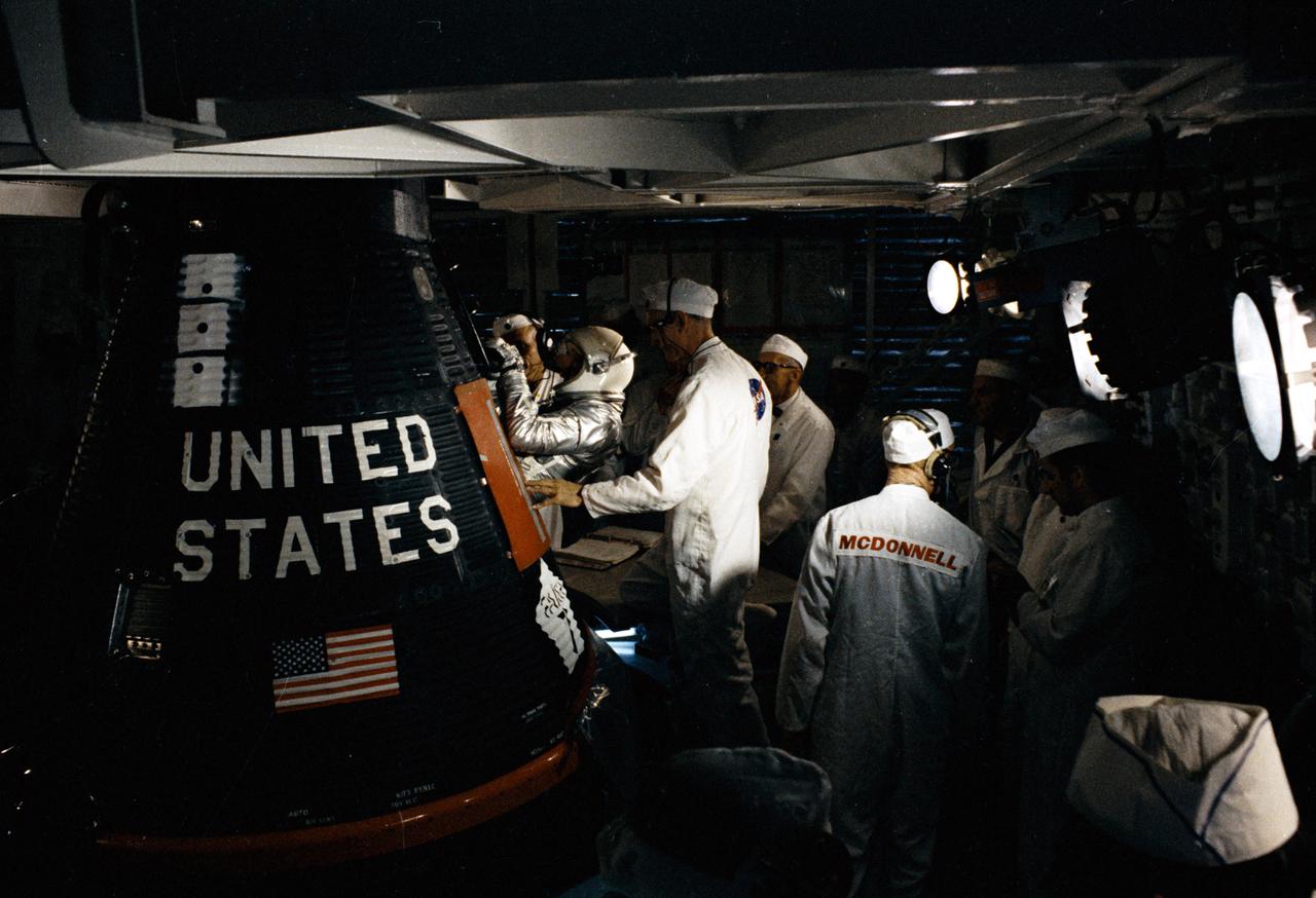 S63-09676-E (15 May 1963) --- Astronaut L. Gordon Cooper Jr., pilot of the Mercury-Atlas 9 (MA-9) Earth-orbital space mission, is assisted into his "Faith 7" Mercury spacecraft during the prelaunch countdown. MA-9 was launched on May 15, 1963, and the flight lasted for 34 hours and 20 minutes. Photo credit: NASA