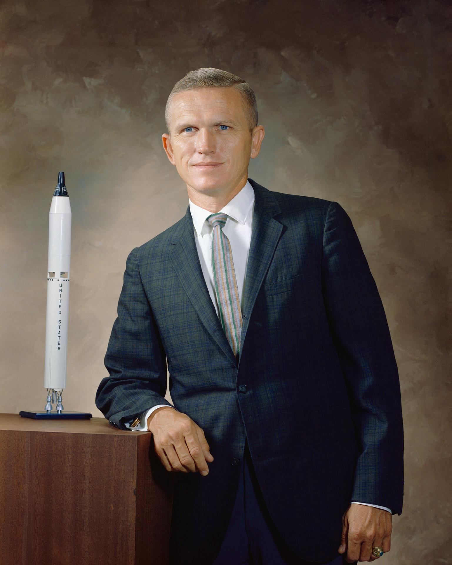 Portrait of astronaut Frank Borman with model shuttle