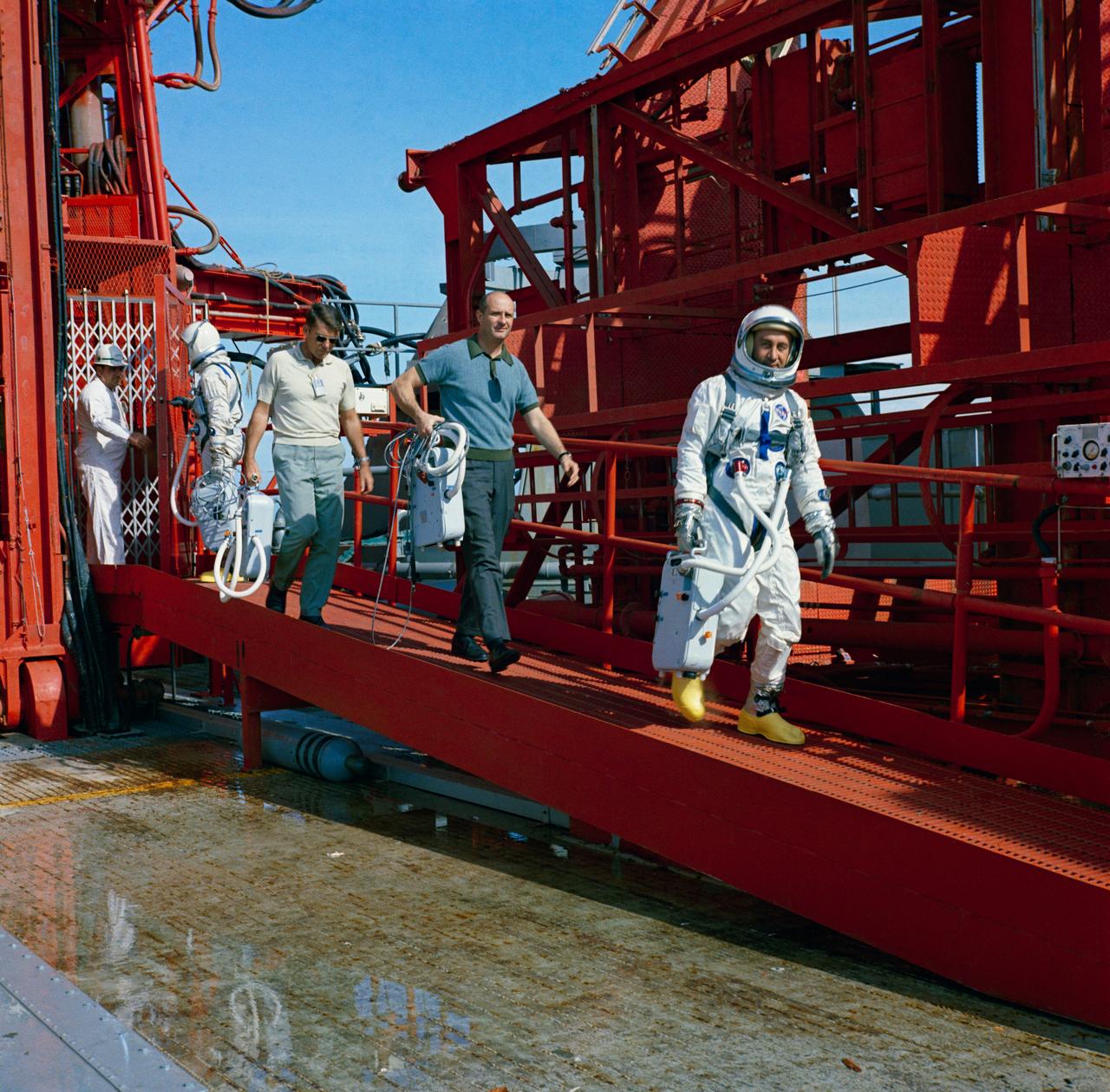 S64-40298 (24 Nov. 1964) --- Astronauts John W. Young, Walter M. Schirra Jr., Thomas P. Stafford and Virgil I. Grissom (left to right) are shown during egress training during Gemini-Titan 3 simulation launch at Pad 19.