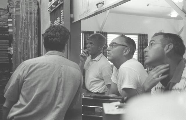 S64-10801 (1962) --- Astronauts M. Scott Carpenter (far left) and John H. Glenn Jr. relax following breakfast during Mercury Atlas 6 (MA-6) preflight activity. Glenn is the MA-6 pilot. Carpenter is the MA-6 backup pilot. Photo credit: NASA