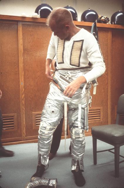 S64-14848 (20 Feb. 1962) --- Astronaut John H. Glenn Jr. dons spacesuit during preflight operations at Cape Canaveral, Feb. 20, 1962, the day he flew his Mercury-Atlas 6 spacecraft, Friendship 7, into orbital flight around Earth. Photo credit: NASA