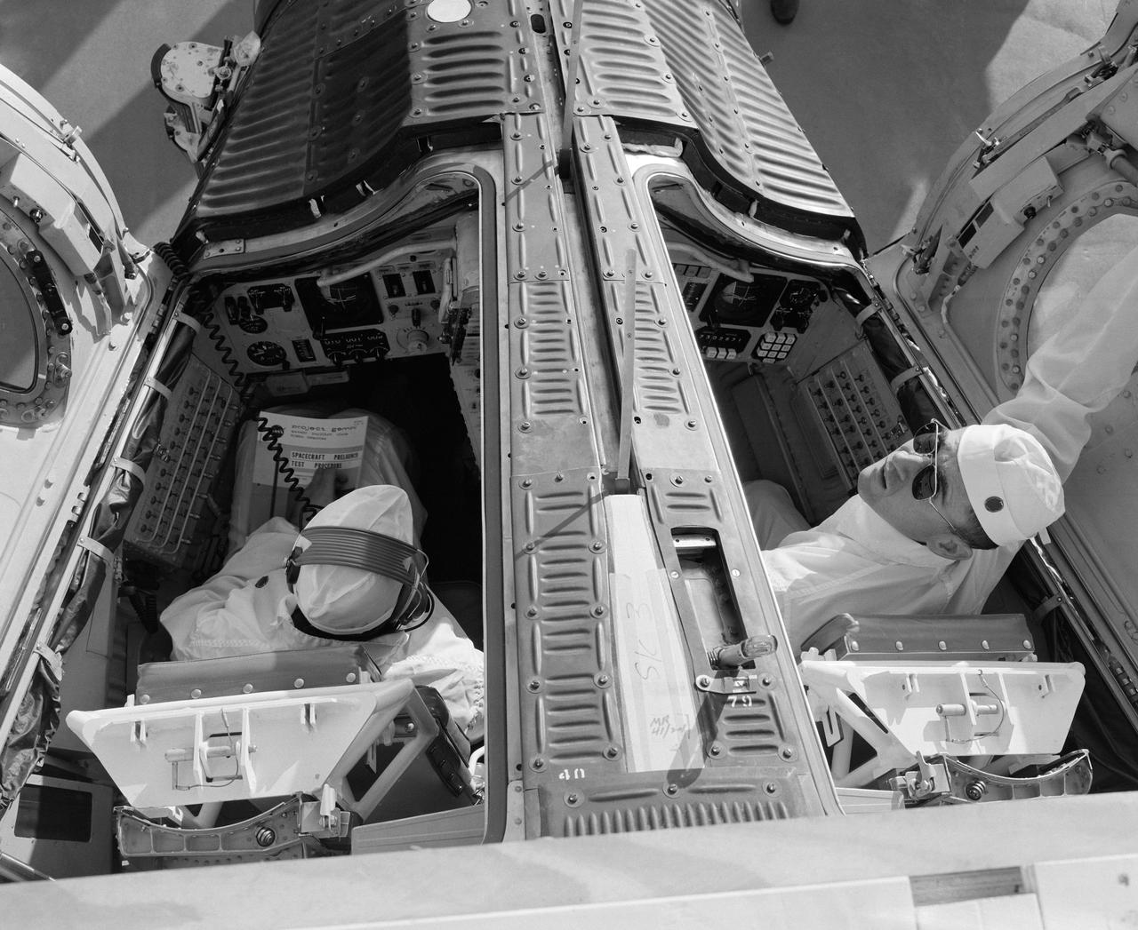 S65-13244 (6 Jan. 1965) --- The Gemini-Titan 3 prime crew, astronauts Virgil I. Grissom (left) and John W. Young, are shown in the Gemini-3 spacecraft during a communications test at the Merritt Island launch area.
