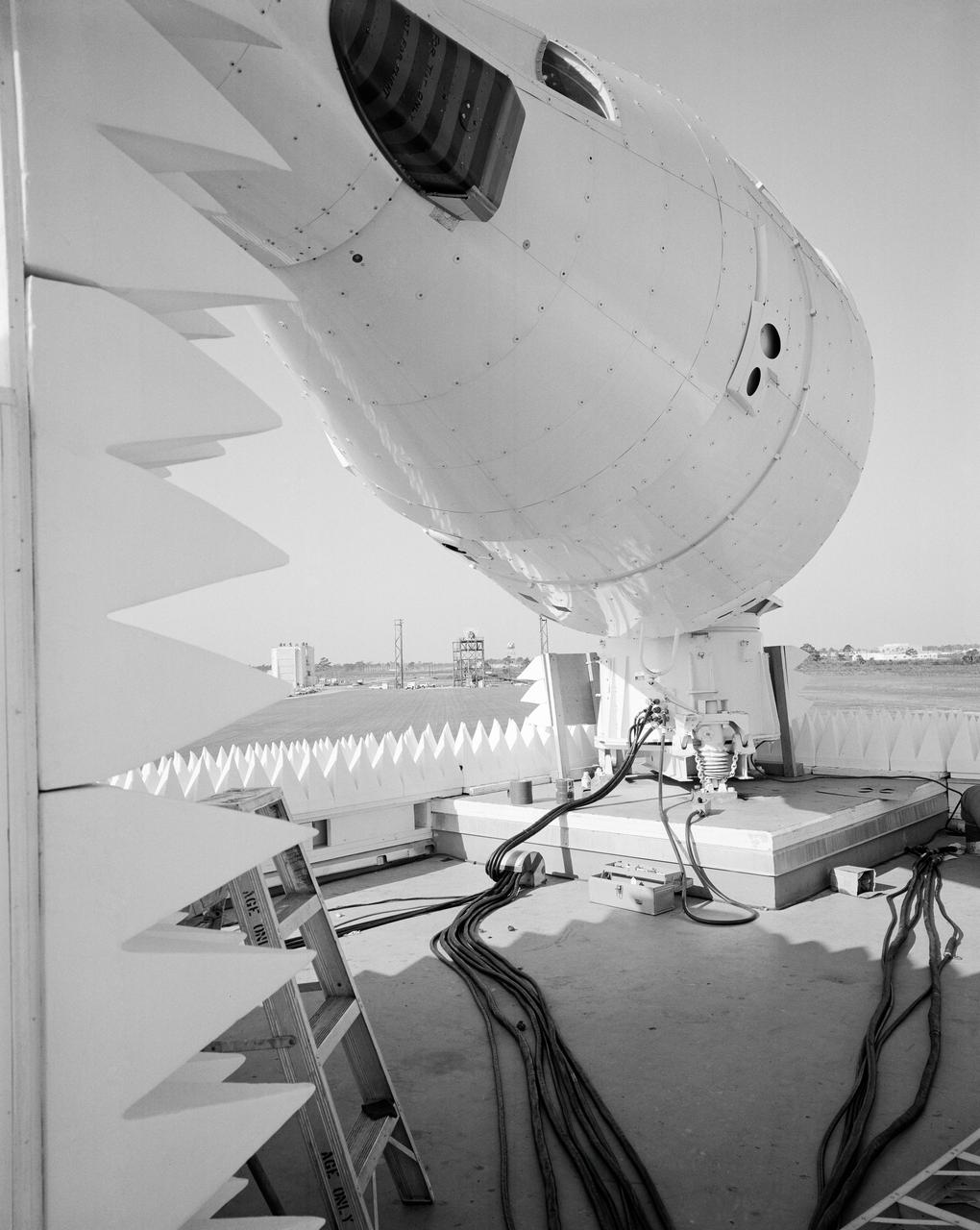 S65-13394 (6 Jan. 1965) --- Gemini-3 spacecraft (background) on tower at Boresight Range, Merritt Island launch area, showing simulator in foreground.