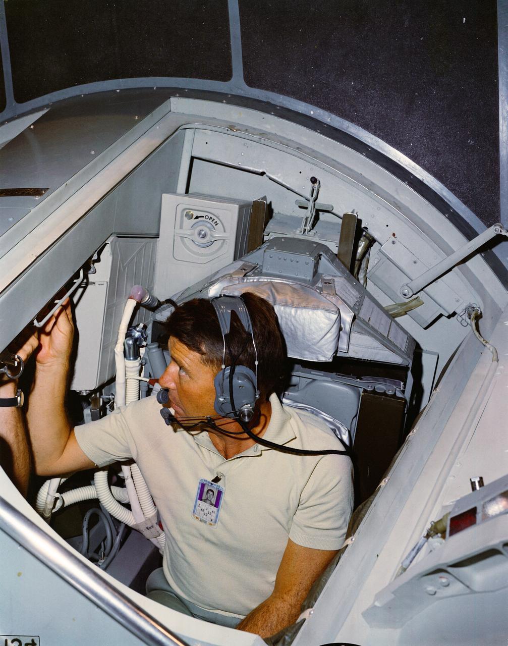 S65-13919 (15 Jan. 1965) --- Astronaut Walter M. Schirra Jr., command pilot of the Gemini-6 prime crew, is pictured in the cockpit of the Gemini simulator at the Mission Control Center at Cape Kennedy, Florida. Photo credit: NASA or National Aeronautics and Space Administration