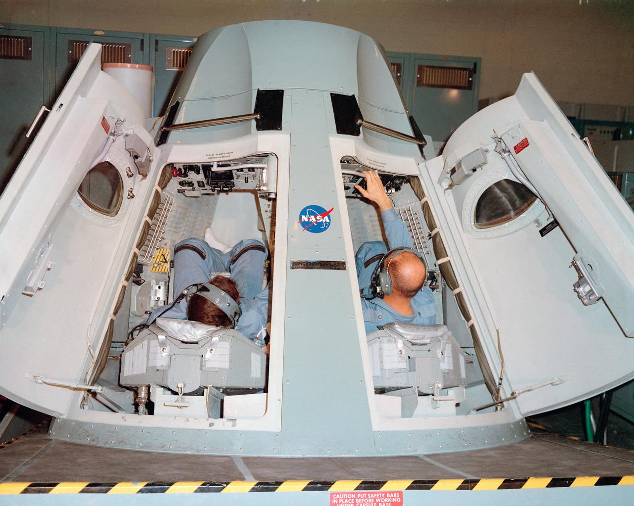 S65-13920 (15 Jan. 1965) --- The Gemini-6 prime crew, astronauts Walter M. Schirra Jr. (left), command pilot, and Thomas P. Stafford, pilot, are pictured in the Gemini simulator during training exercises at the Mission Control Center at Cape Kennedy, Florida. Photo credit: NASA or National Aeronautics and Space Administration