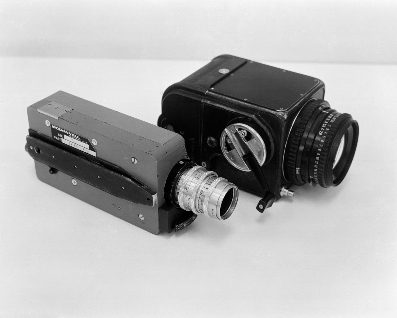 S65-17399 (March 1965) --- Two cameras which will be used on the Gemini-Titan 3 orbital flight. The lighter colored one is a McDonnell 16mm sequential camera, having a 120-feet film capacity, and a 25mm f/1.9 lens. The black camera is a modified Hasselblad, hand-held, with a 70mm flimback, using an 80mm f/2.8 lens.