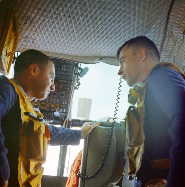 NASA image: Astronauts Grissom and Young aboard helicopter after retrieval from Gemini 3