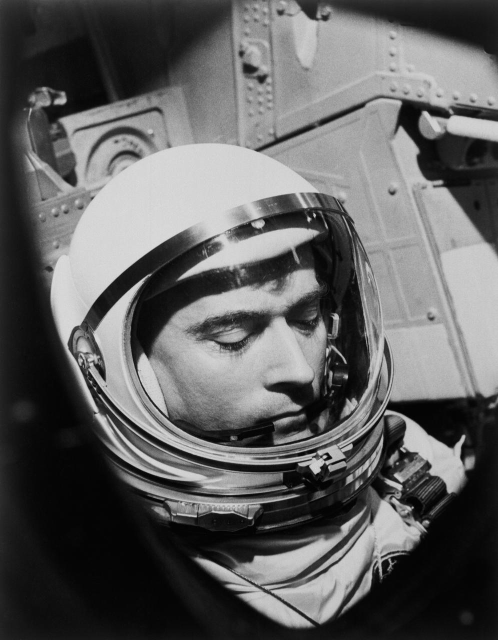 S65-19228 (23 March 1965) --- Astronaut John W. Young, the pilot of the Gemini-Titan 3 mission, is shown going through last minute checks before the hatch is closed on the spacecraft.  The window frames Young just before the launch.