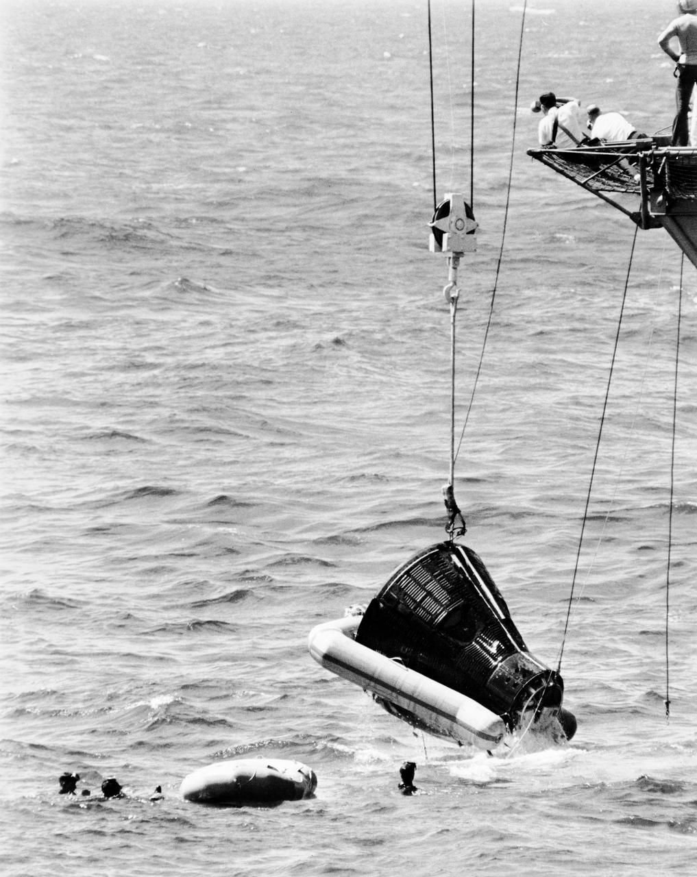 The Gemini-4 Astronauts is shown being hoisted aboard the Aircraft Carrier USS Wasp. The flotation collar is still attached to the spacecraft. DOWNRANGE RECOVERY AREA, ATLANTIC OCEAN B&W