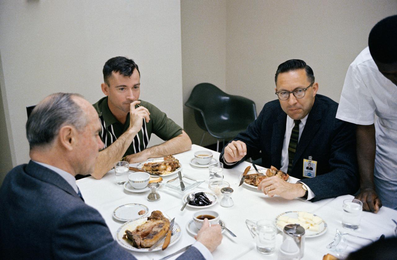 S65-20428 (23 March 1965) --- Astronaut John W. Young (center), pilot of the Gemini-Titan 3 flight, is shown during a steak breakfast which he was served about two hours prior to the 9:24 a.m. (EST) GT-3 launch. At left is J.S. McDonnell, board chairman and Chief Executive Officer of the McDonnell Aircraft Corporation. Dr. Charles A. Berry, chief of Center Medical Programs, is at right.