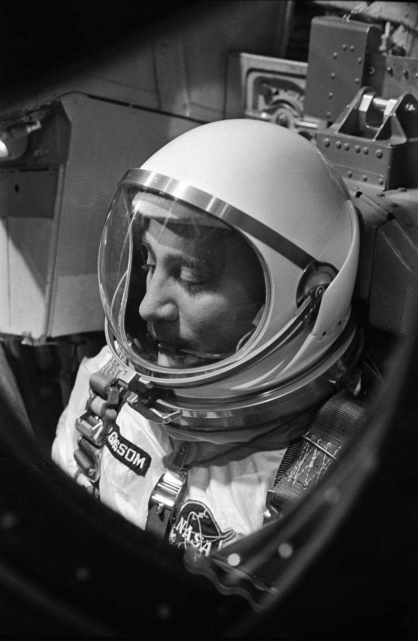 S65-20605 (23 March 1965) --- Astronaut Virgil I. Grissom, the command pilot of the Gemini-Titan 3 mission, is shown through the window of the open hatch on the Gemini spacecraft in the white room on the morning of the launch.