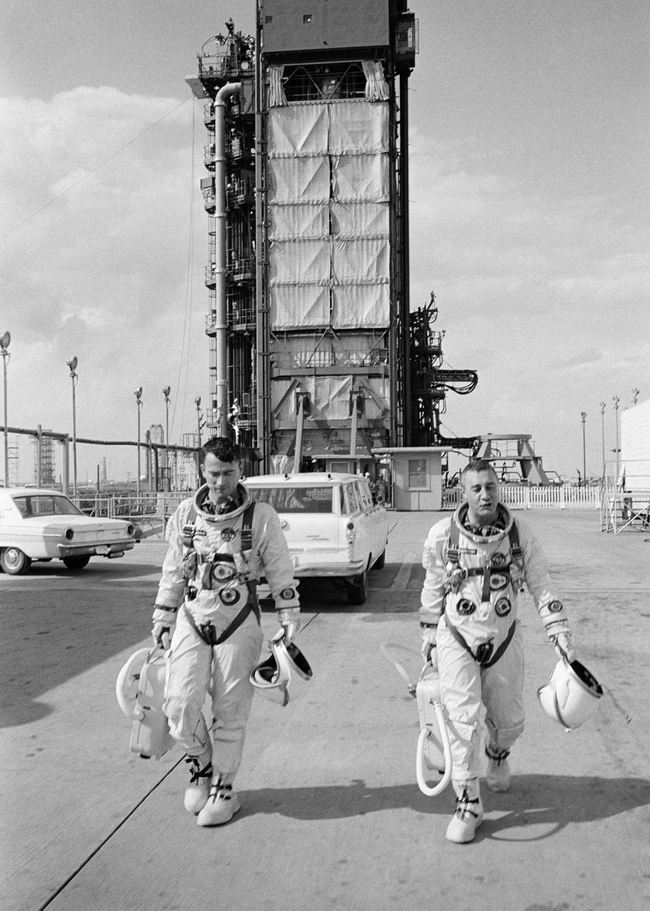 S65-20641 (1965) --- Astronauts John W. Young (left), pilot, and Virgil I. Grissom, command pilot, for the Gemini-Titan 3 flight, are shown leaving the launch pad after simulations in the Gemini-3 spacecraft.