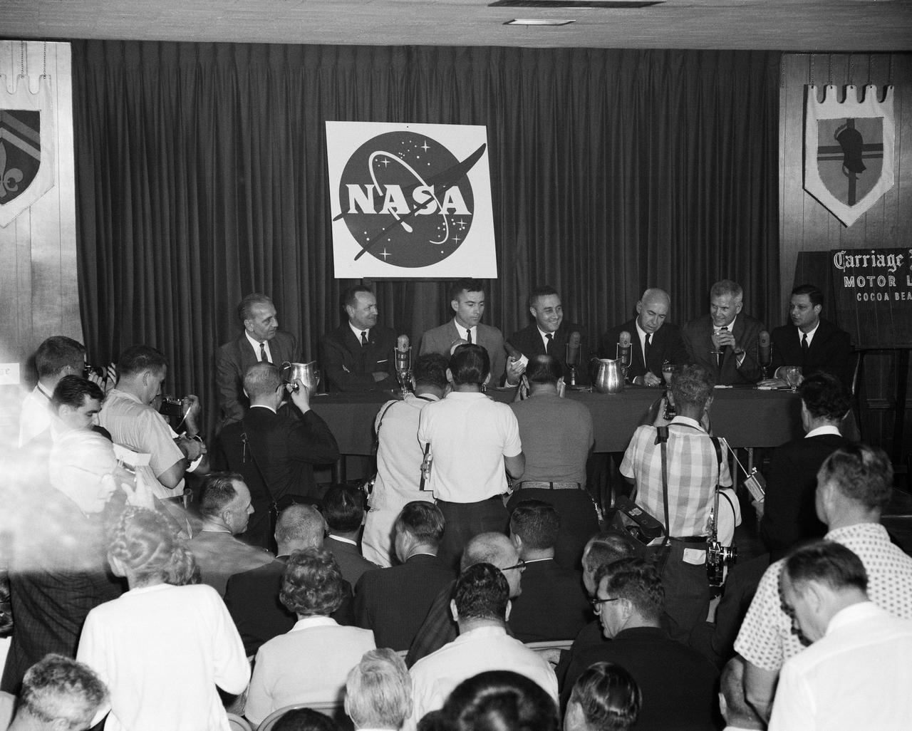 S65-20864 (25 March 1965) --- News conference held at the Carriage House press site the day after the successful Gemini-Titan 3 three-orbit mission. Being interviewed at the press table by news media are (left to right) Dr. Kurt H. Debus, director of Kennedy Space Center; Christopher C. Kraft Jr., MSC assistant director for Flight Operations; astronaut John W. Young, pilot of the GT-3 flight; astronaut Virgil I. Grissom, command pilot of the GT-3 mission; Dr. Robert R. Gilruth, MSC director; Dr. Robert C. Seamans, NASA associate administrator; and Julian Scheer, assistant administrator, Office Of Public Affairs, NASA.