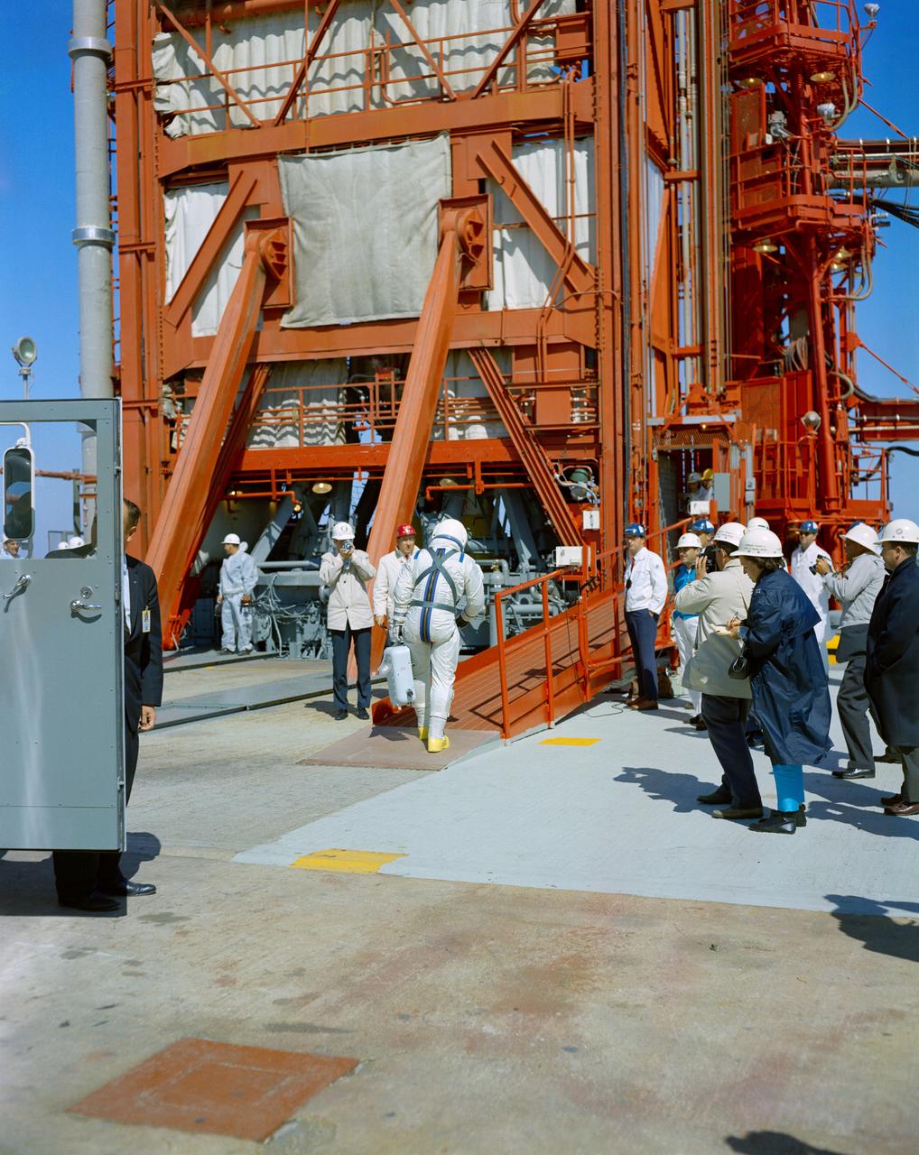 S65-20994 (23 March 1965) --- A member of the Gemini-Titan 3 prime crew is seen walking onto the gantry ramp at Pad 19 after getting out of a transport van parked at left. The other astronaut is still in the van. The two astronauts then rode the elevator to the top of the launch vehicle to enter the Gemini-3 spacecraft. The GT-3 liftoff was at 9:24 a.m. (EST) on March 23, 1965. The Gemini-3 spacecraft carried astronauts Virgil I. Grissom and John W. Young on three successful orbits of Earth.