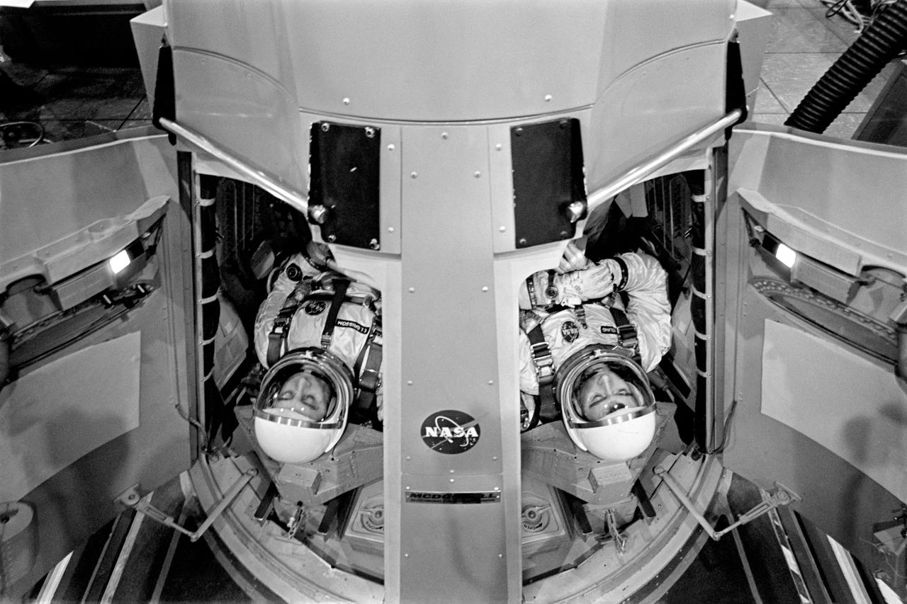 S65-21864 (19 March 1965) --- Astronauts Virgil I. Grissom (left), command pilot; and John W. Young, pilot, prepare to run Gemini-Titan 3 simulations in the Gemini mission simulator at Cape Kennedy, Florida. The NASA GT-3 flight was scheduled for March 23, 1965.