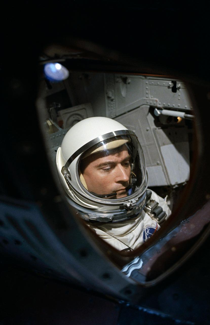 View of Astronaut John W. Young through spacecraft window prior to launch of Gemini-Titan 3 mission.