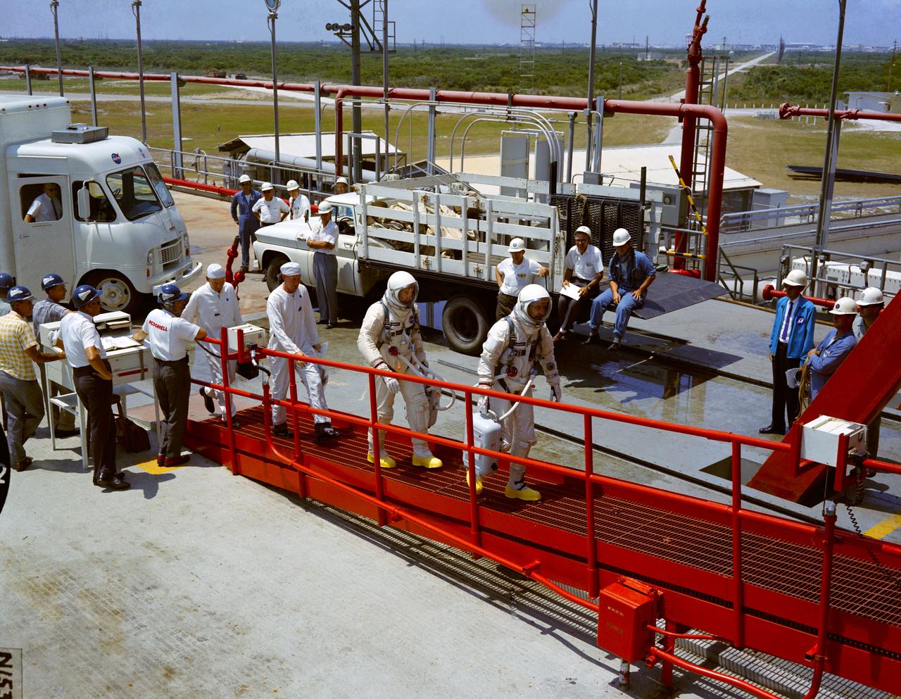 Astronauts White and James A. McDivitt are shown walking up the ramp toward the gantry elevator at Pad 19.                                CAPE KENNEDY, FL                             CN