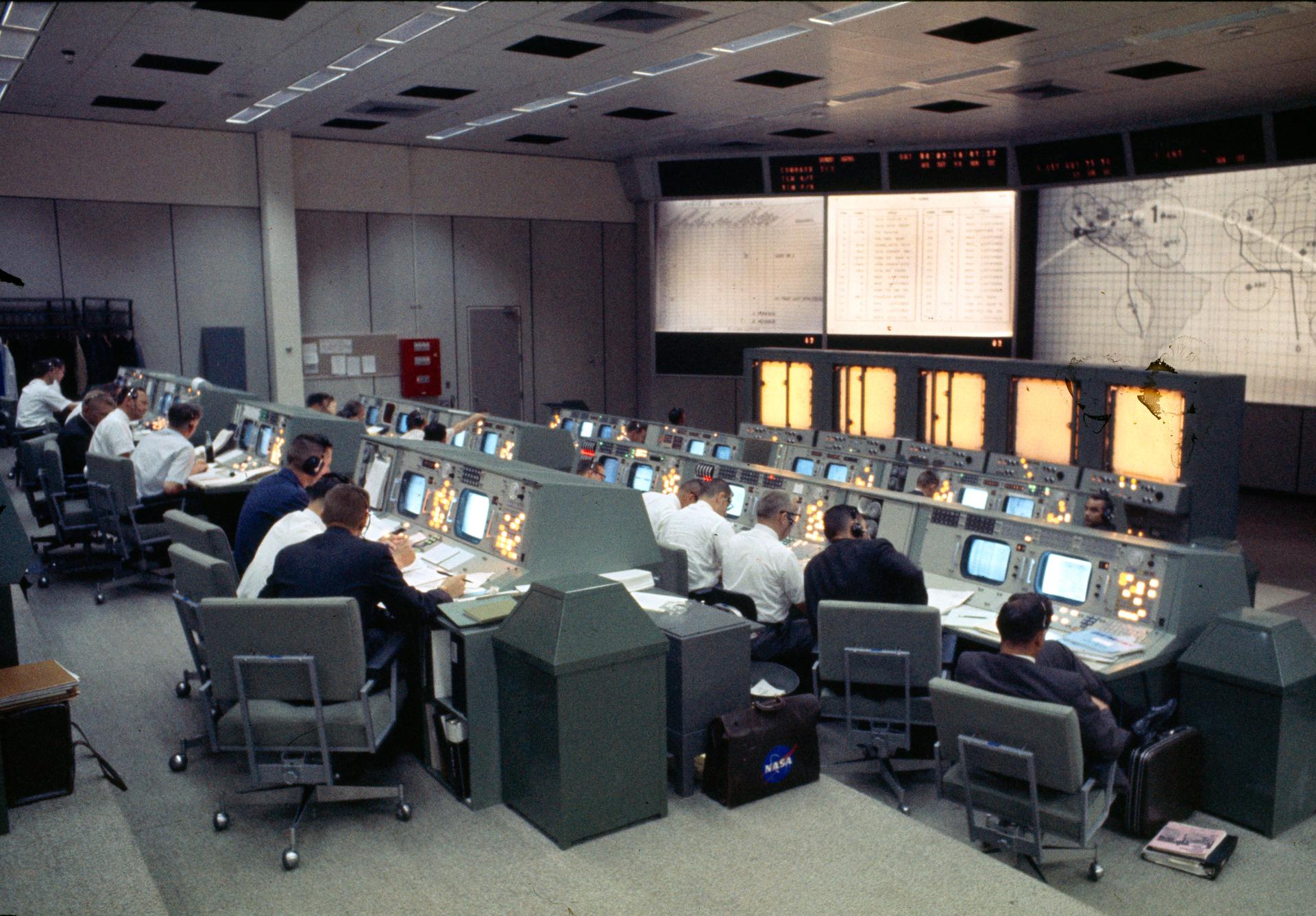 Flight controllers work at their consoles in Mission Control Center during the Gemini-Titan 4 mission