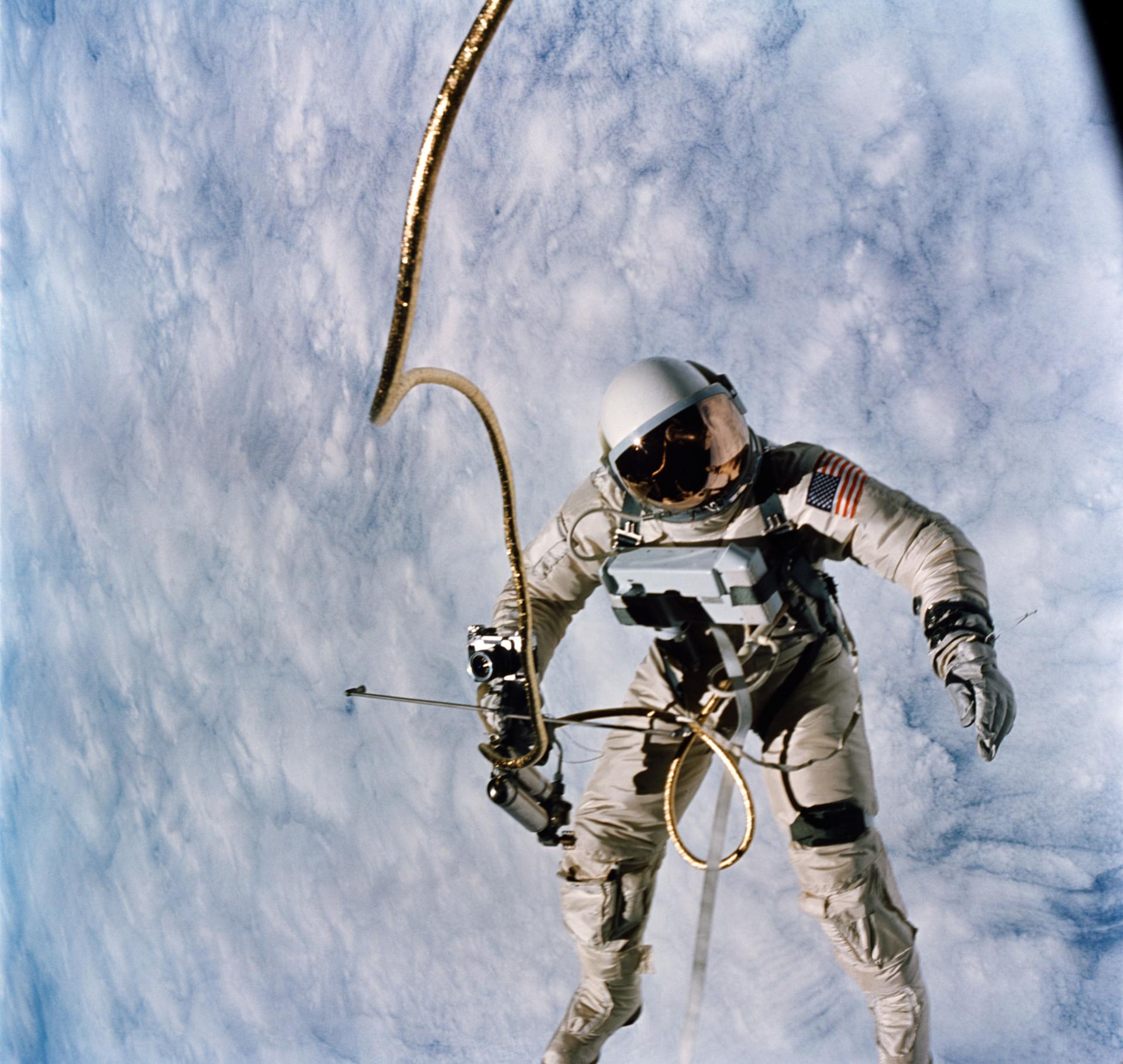 Astronaut Ed White floats in space above the planet on the Gemini Titan 4 flight