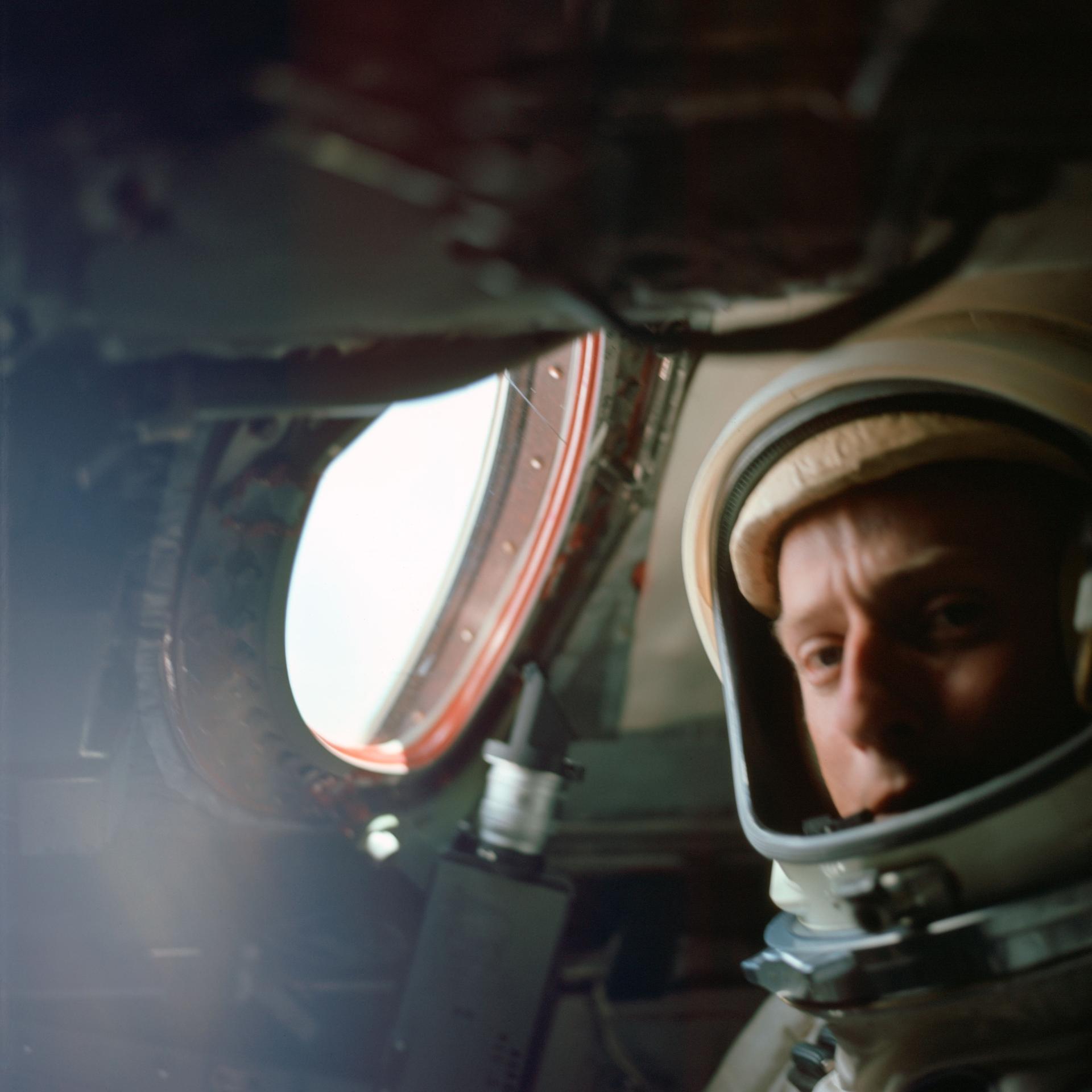 Astronaut Charles Conrad Jr. inside the Gemini V spacecraft as it orbited Earth.