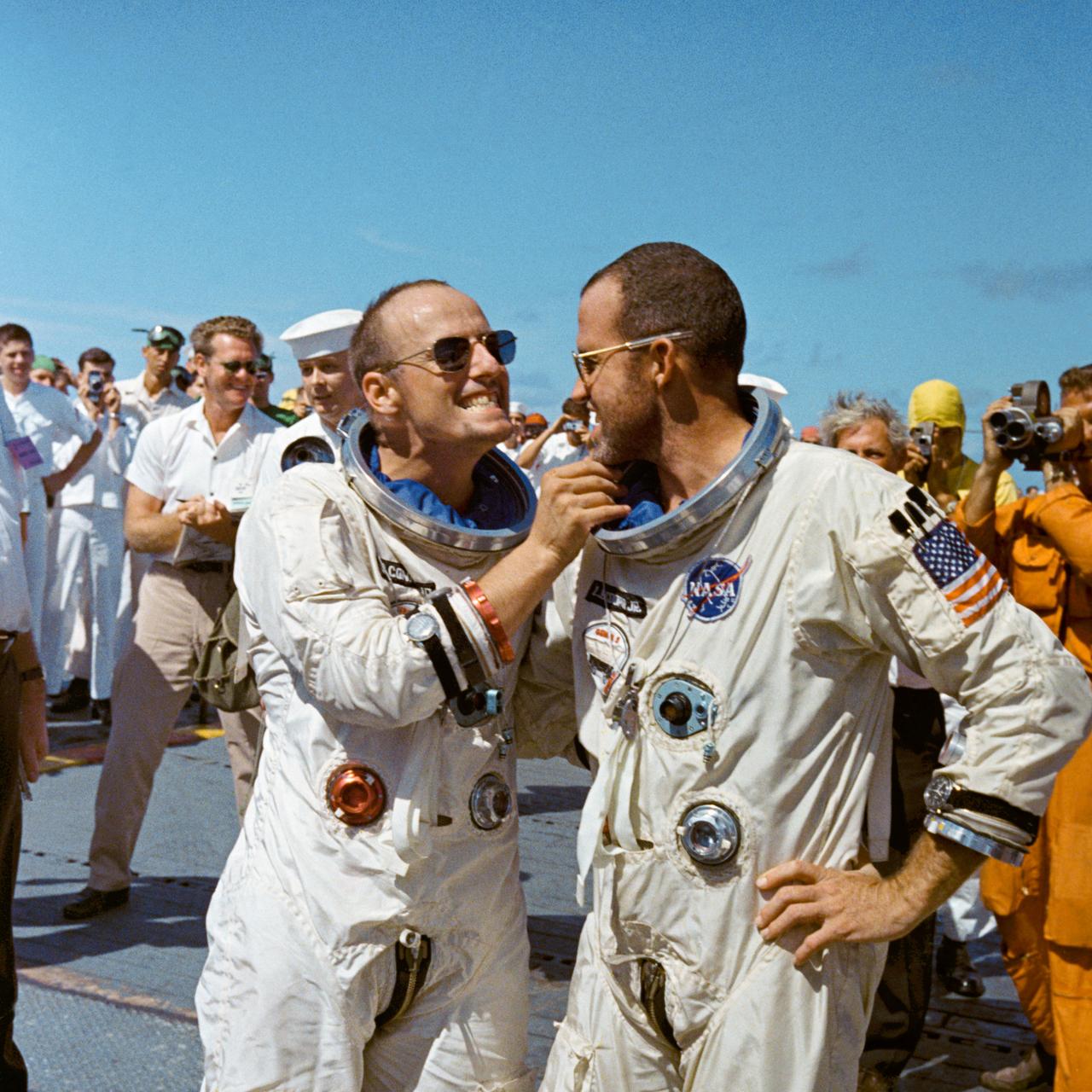 S65-46638 (29 Aug. 1965) --- Astronaut Charles Conrad Jr. tweaks astronaut L. Gordon Cooper's eight-day growth of beard for the cameramen while onboard the prime recovery vessel after their Gemini-5 flight.