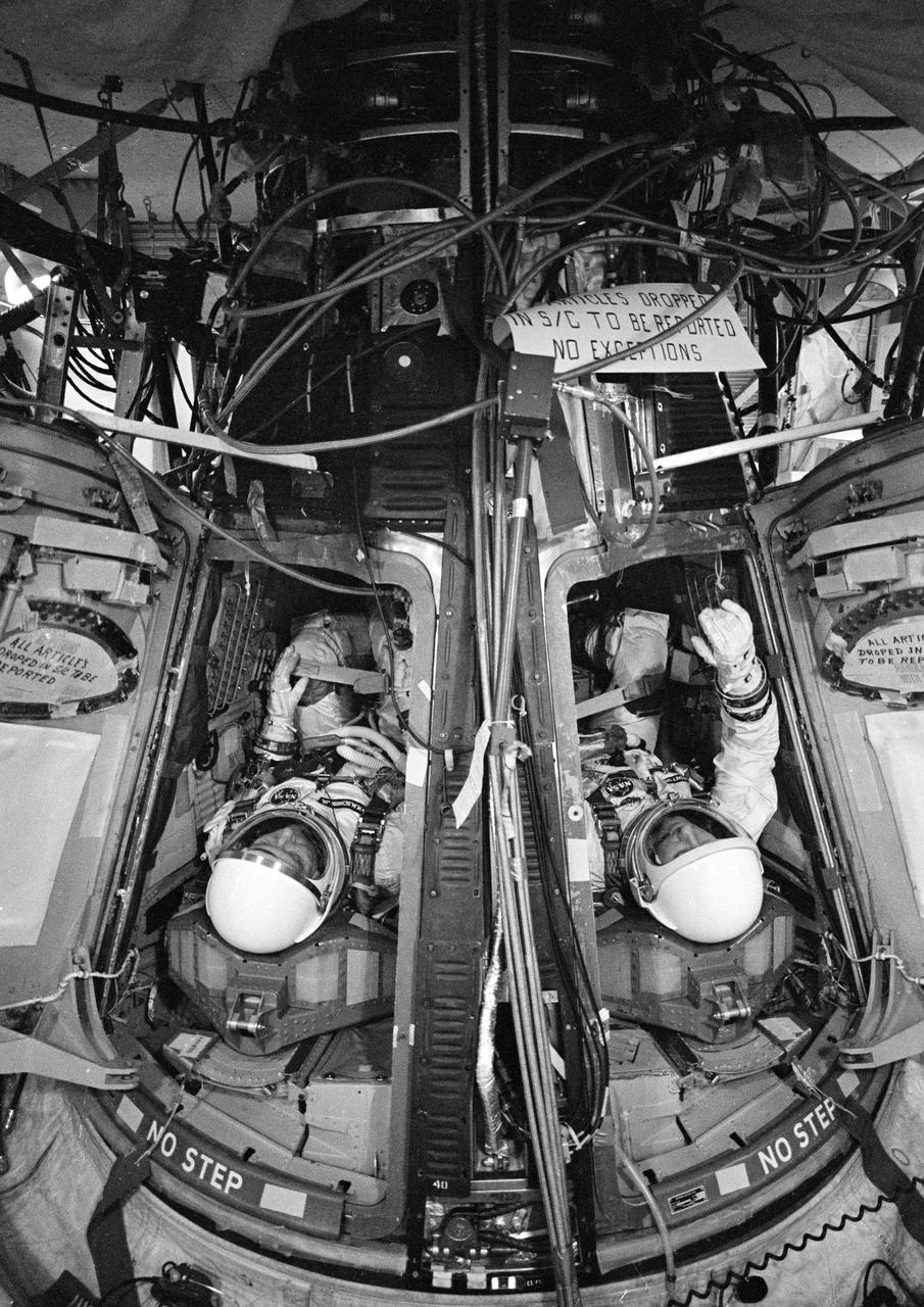 S65-56177 (1965) --- Gemini-6 astronauts Walter M. Schirra Jr., command pilot, and Thomas P. Stafford, pilot, check out the spacecraft during a simulated test at Launch Complex 19 at Cape Canaveral, Florida. Photo credit: NASA or National Aeronautics and Space Administration
