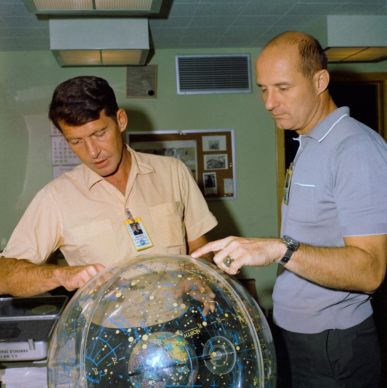 S65-56185 (21 Oct. 1965) --- Gemini-6 astronauts Walter M. Schirra Jr. (left), command pilot; and Thomas P. Stafford, pilot, look at a star globe for celestial pattern recognition for their upcoming flight. The National Aeronautics and Space Administration (NASA) plans a two-day mission for Gemini-6 for the astronauts to develop the ability to rendezvous and dock with an orbiting Agena Target Docking Vehicle. Photo credit: NASA or National Aeronautics and Space Administration