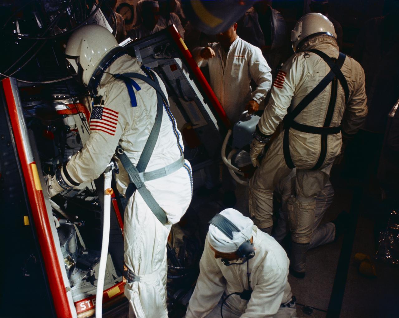 S65-56196 (25 Oct. 1965) --- Astronauts Walter M. Schirra Jr., command pilot; and Thomas P. Stafford, pilot, stand in the white room atop Pad 19 awaiting insertion into their Gemini-6 spacecraft during the prelaunch countdown of the Gemini-Titan-Agena 6 space mission. However, the Gemini-6 liftoff scheduled for Oct. 25 never occurred. The Agena, intended as a rendezvous target vehicle in the mission, failed to achieve orbit. Photo credit: NASA or National Aeronautics and Space Administration