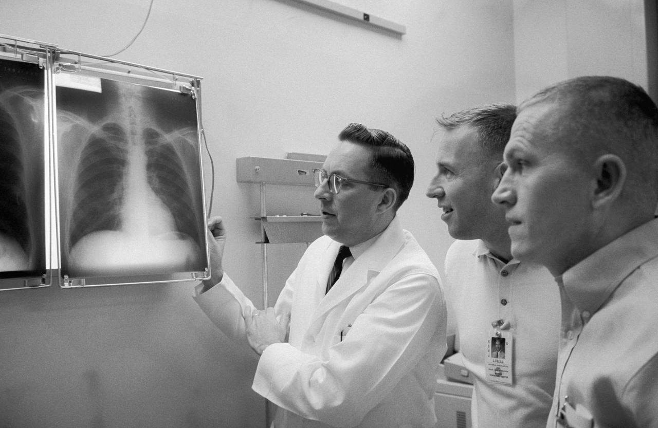 S65-56315 (2 Dec. 1965) --- Dr. Charles A. Berry (left), chief of the Manned Spacecraft Center (MSC) Medical Programs, and astronauts James A. Lovell Jr. (center), Gemini-7 pilot, and Frank Borman, Gemini-7 command pilot, examine a series of chest x-rays taken during the preflight physical. Photo credit: NASA