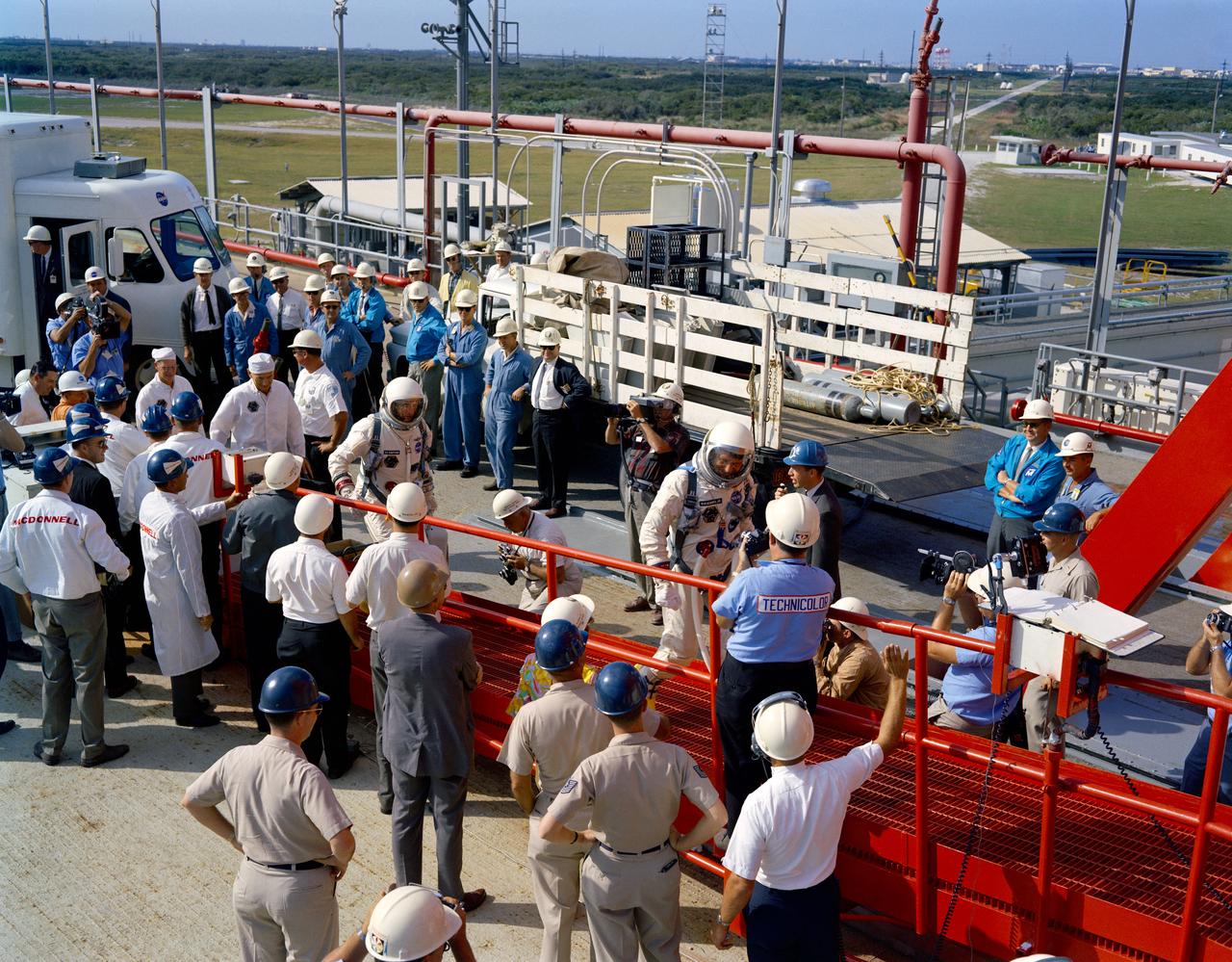 S65-57962 (25 Oct. 1965) --- The Gemini-6 prime crew arrives at Pad 19 during the Gemini-6 countdown. Leading up the ramp is astronaut Walter M. Schirra Jr., command pilot, followed by astronaut Thomas P. Stafford, pilot. Moments later they entered the spacecraft in the white room atop the Titan launch vehicle. Since the Agena, intended as a rendezvous target vehicle in the Gemini-6 mission, failed to achieve orbit, the Oct. 25 launch was scrubbed. Photo credit: NASA or National Aeronautics and Space Administration