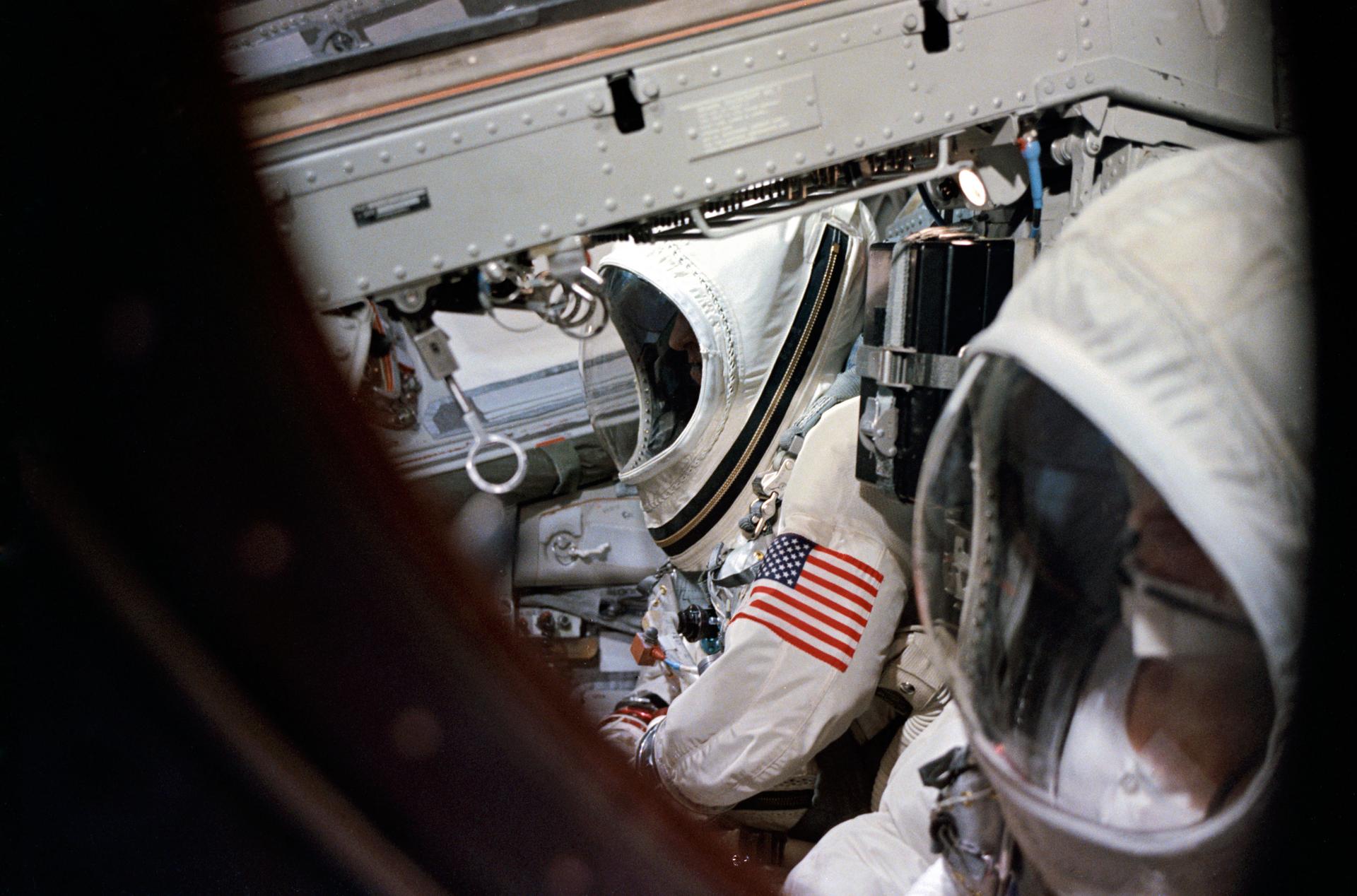 Astronauts Frank Borman (foreground), and James Lovell Jr., are sealed into their spacecraft prior to launch