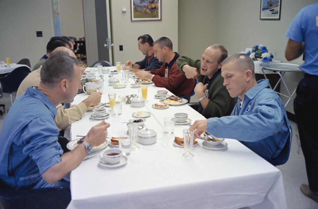 S65-59927 (4 Dec. 1965) --- Fellow astronauts join the Gemini-7 prime crew for breakfast in the Manned Spacecraft Operations Building, Merritt Island, on the day of the Gemini-7 launch. Clockwise around the table, starting lower left, are astronauts James A. Lovell Jr., Gemini-7 prime crew pilot; Walter M. Schirra Jr., Gemini-6 prime crew command pilot; Donald K. Slayton, MSC assistant director for Flight Crew Operations; Virgil I. Grissom, Gemini-6 backup crew command pilot; Charles Conrad Jr., Gemini-5 prime crew pilot; and Frank Borman, Gemini-7 prime crew command pilot. Photo credit: NASA