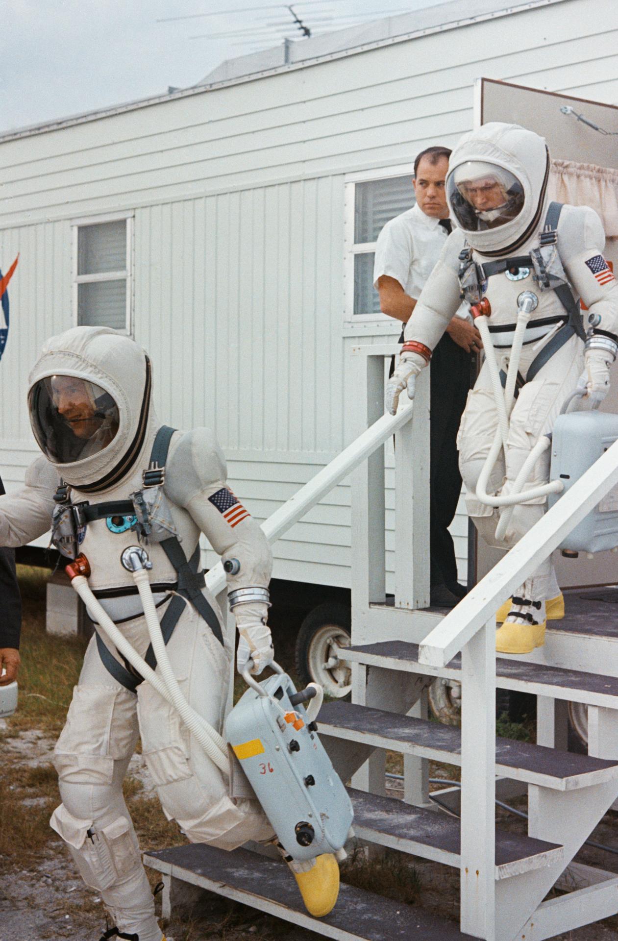 Jim Lovell (front) and Frank Borman descend stairs wearing their space suits before making their way to the Gemini 7 spacecraft for launch