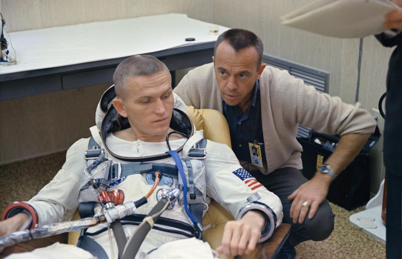 S65-61755 (4 Dec. 1965) --- Astronaut Frank Borman, command pilot of the National Aeronautics and Space Administration's Gemini-7 spaceflight, talks with astronaut Alan Shepard, chief, MSC Astronaut Office, in the suiting up trailer at Launch Complex 16, during the Gemini-7 prelaunch countdown. A 14-day mission in space is scheduled for astronaut Borman and James A. Lovell Jr., pilot. The Gemini-7 liftoff occurred at 2:30 p.m. (EST) on Dec. 4, 1965. Photo credit: NASA