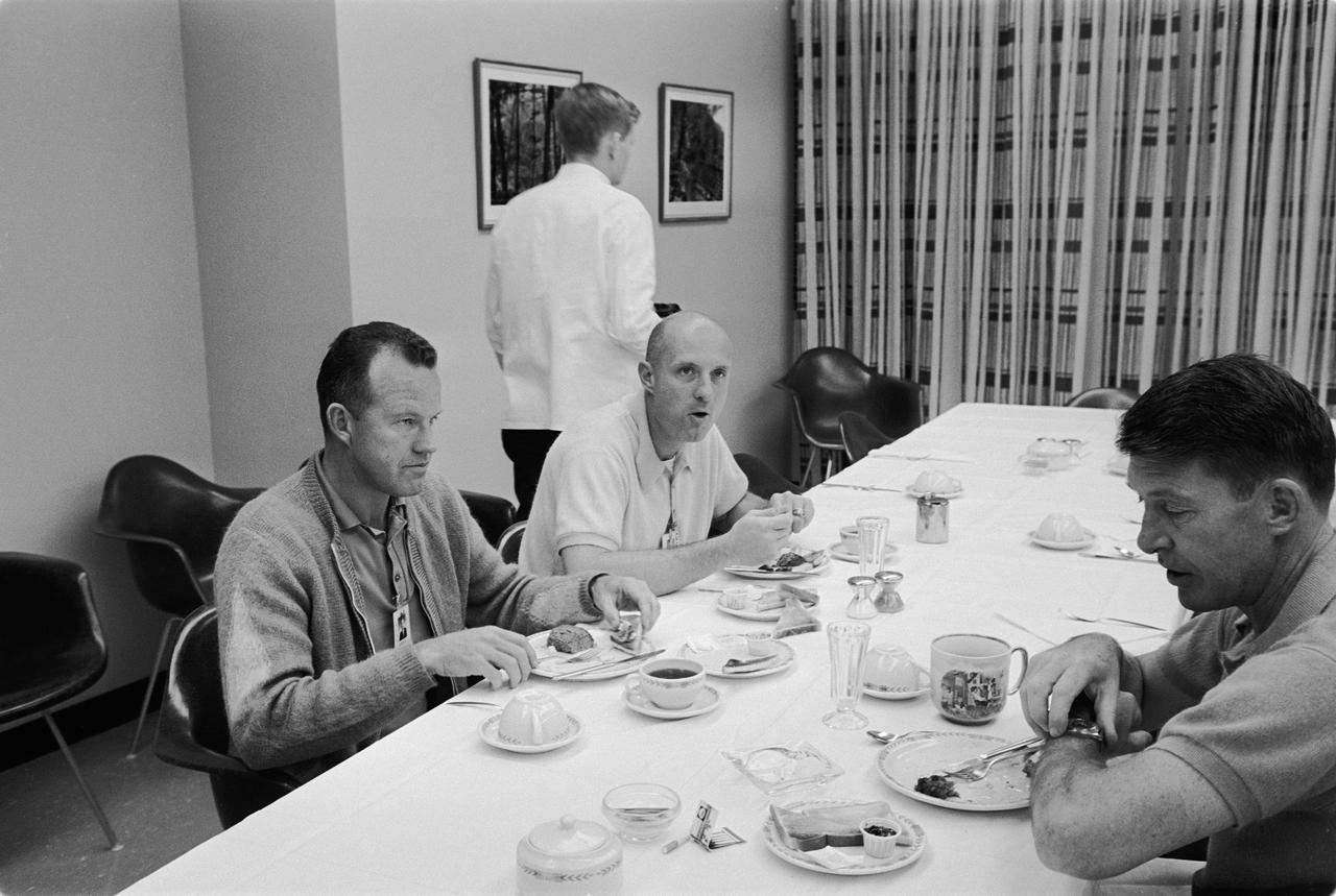 S65-61789 (12 Dec. 1965) --- Astronauts Walter M. Schirra Jr. (right), Gemini-6 command pilot; and Thomas P. Stafford (center), pilot, enjoy a prelaunch breakfast on the morning of the proposed launch of NASA's two-day Gemini-6 spaceflight. At left is astronaut L. Gordon Cooper Jr., command pilot of the Gemini-5 space mission. An attempt was made to launch Gemini-6 from Pad 19 at 9:54 a.m. (EST) on Dec. 12, 1965. However, seconds after ignition, the first stage engine of the Gemini-6 launch vehicle shut down due to a faulty release of a liftoff umbilical plug. Photo credit: NASA or National Aeronautics and Space Administration