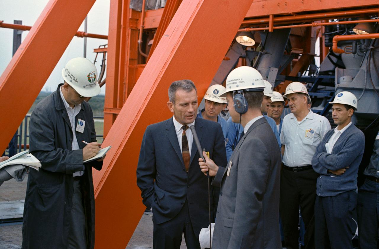 S65-61846 (5 Dec. 1965) --- Donald K. Slayton, assistant director for Flight Crew Operations, talks with newsmen after examining damage to Pad 19 at Kennedy Space Center, following liftoff of the Gemini-7 spacecraft on Dec. 4, 1965. Damage was slight and will be repaired quickly for the planned launch of Gemini-6. Photo credit: NASA