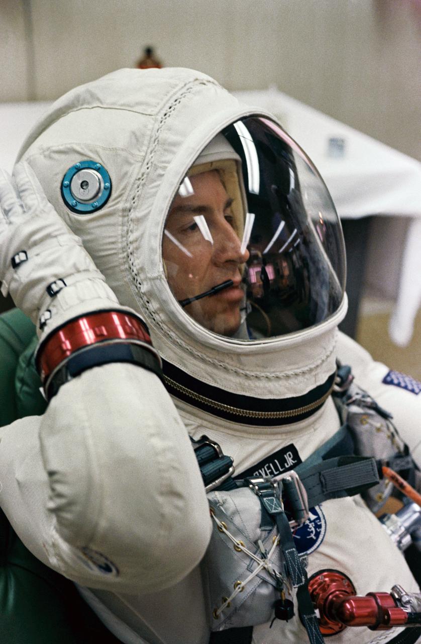 S65-61849 (4 Dec. 1965) --- Astronaut James A. Lovell Jr., pilot of the Gemini-7 spaceflight, relaxes in the suiting up trailer at Launch Complex 16, during the Gemini-7 prelaunch countdown at Cape Kennedy, Florida. Lovell wears the new lightweight spacesuit specially designed for long-duration flights. Photo credit: NASA