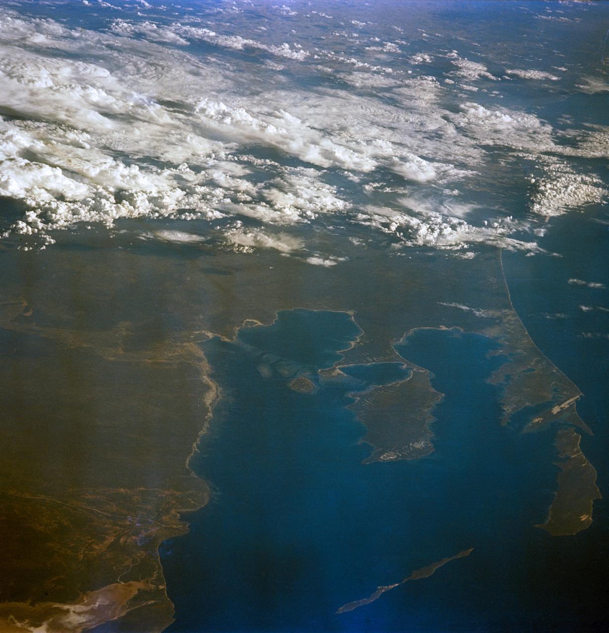 S65-63136 (16 Dec. 1965) --- Shark Bay area on the western coast of Western Australia as seen from the Gemini-6 spacecraft during its 16th revolution of Earth. City of Carnarven, where NASA has a tracking station, is located near the bottom of picture in lower left corner, near mouth of stream. Indian Ocean is body of water at upper right. South is toward top of picture. Photo credit: NASA or National Aeronautics and Space Administration