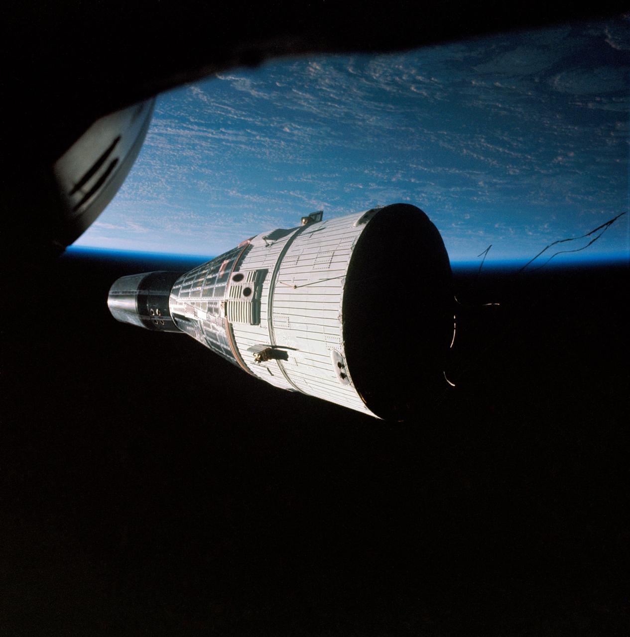 S65-63197 (15 Dec. 1965) --- This historic view of the orbiting Gemini-7 spacecraft was taken from the Gemini-6 spacecraft during their rendezvous mission in space. Astronauts Frank Borman and James A. Lovell Jr. were in the Gemini-7 spacecraft. In the Gemini-6 spacecraft were astronauts Walter M. Schirra Jr. and Thomas P. Stafford. This photograph was taken with a modified 70mm Hassleblad camera, using Eastman Kodak, Ektachrome MS (SO 217) color film. The two National Aeronautics and Space Administration (NASA) spacecraft?s are approximately 34 feet apart. Photo credit: NASA or National Aeronautics and Space Administration