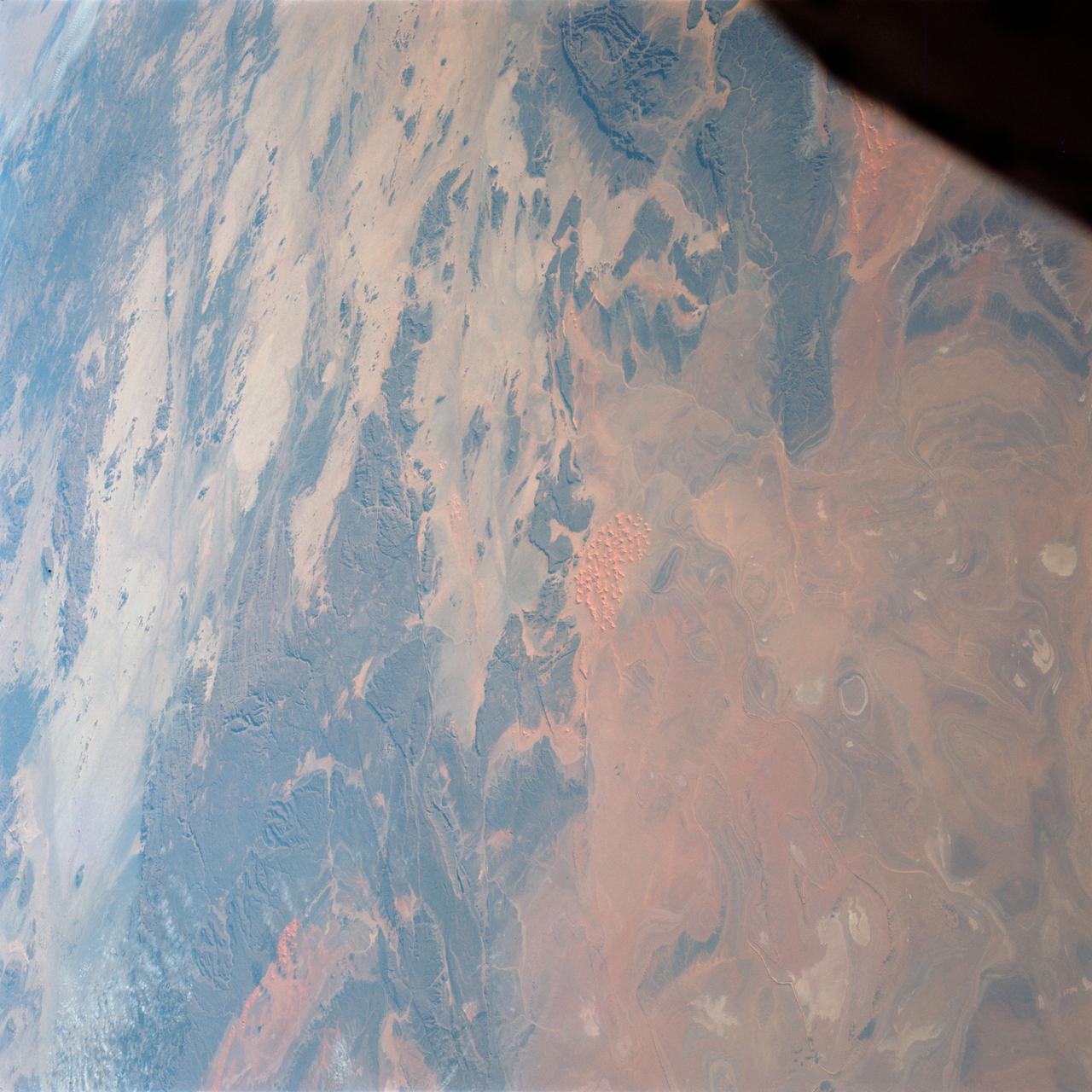 S65-63784 (7 Dec. 1965) --- Algeria, south of Celemb Bechar, as seen from the orbiting Gemini-7 spacecraft during its 42nd revolution of Earth. Note rain runoff on the desert floor. Astronaut Frank Borman and James A. Lovell Jr. were aboard the National Aeronautics and Space Administration?s Gemini-7 spacecraft. The photograph was taken with a modified 70mm Hasselblad camera, using Eastman Kodak, Ektachrome MS (S.O. 217) color film. Photo credit: NASA