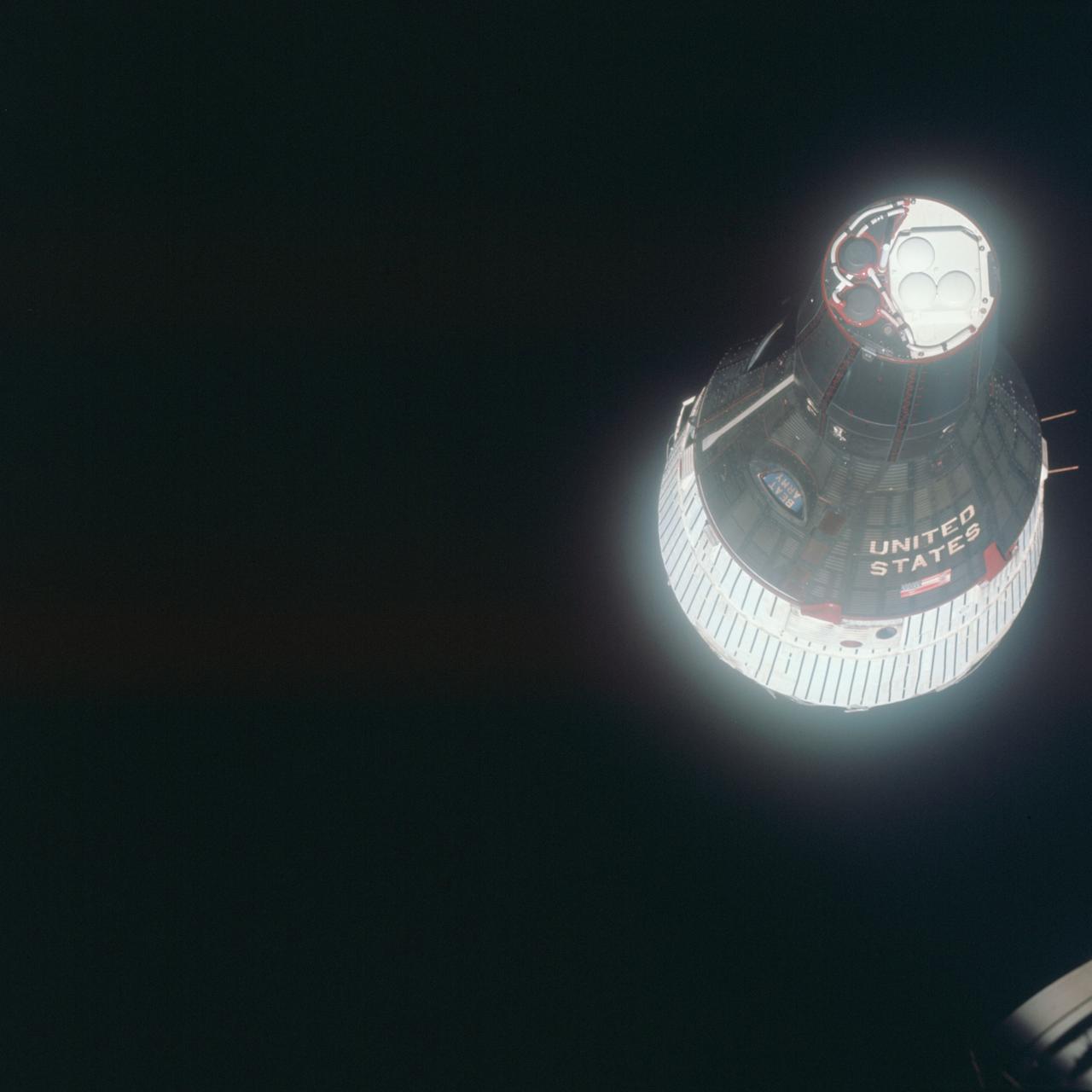 S65-64040 (15 Dec. 1965) --- Nose-on view of the Gemini-6 spacecraft against the blackness of space as seen from Gemini-7 spacecraft.  The two spacecraft were approximately 38 feet apart. Astronauts Walter M. Schirra and Thomas P. Stafford were onboard the Gemini-6 spacecraft. Astronauts Frank Borman and James A. Lovell Jr. were aboard the Gemini-7 spacecraft. A "Beat Army" sign can be seen in the Gemini-6 window. Photo credit: NASA